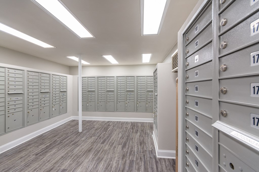 A room with a row of filing cabinets on the right and a row of filing cabinets on the left.