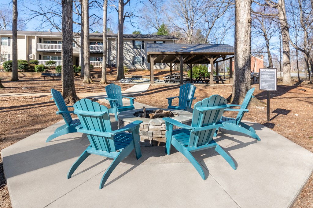A set of six blue chairs are arranged around a table.