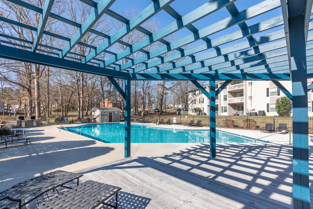 A blue shaded area with a pool in the background at Madison Woods apartments in Greensboro, NC..