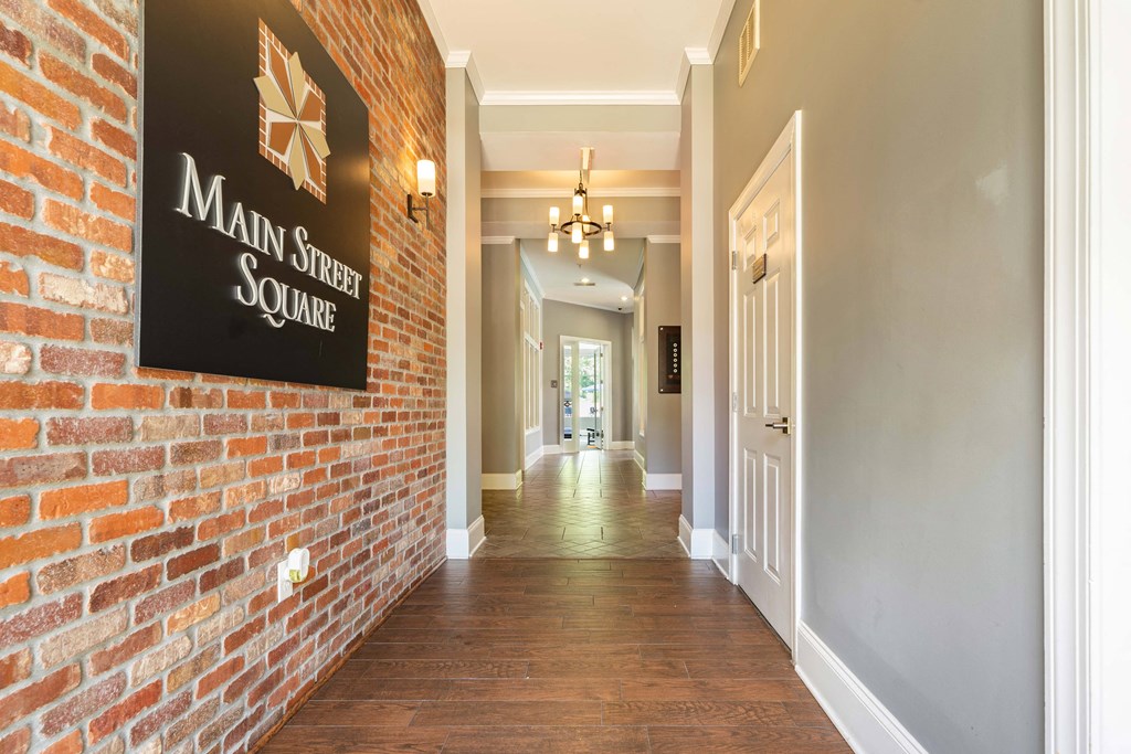 a hallway with a brick wall and a sign that reads main street square