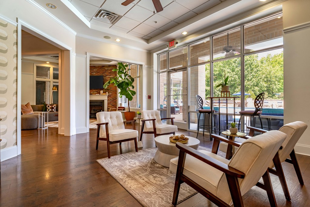 a living room with a fireplace and a table and chairs