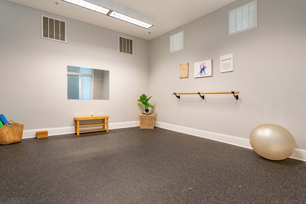 an empty room with a yoga ball and a table