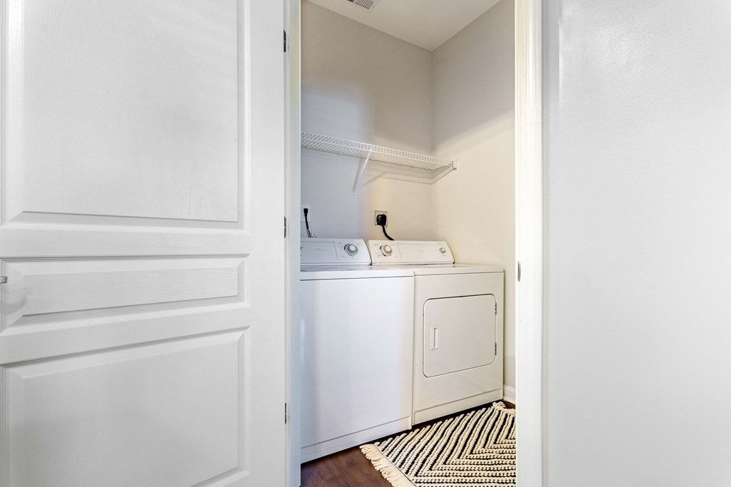 an empty laundry room with a washer and dryer in it
