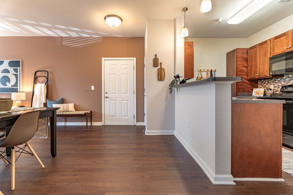 a living room with a kitchen and a table with chairs