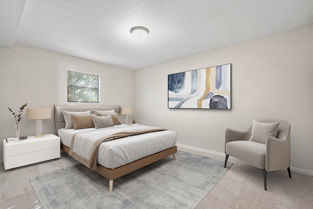 a white bedroom with a bed and a chair