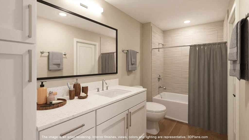 a bathroom with a large mirror and a sink and a toilet