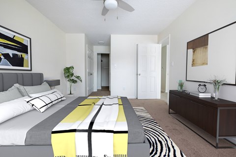 a bedroom with a large bed and a ceiling fan