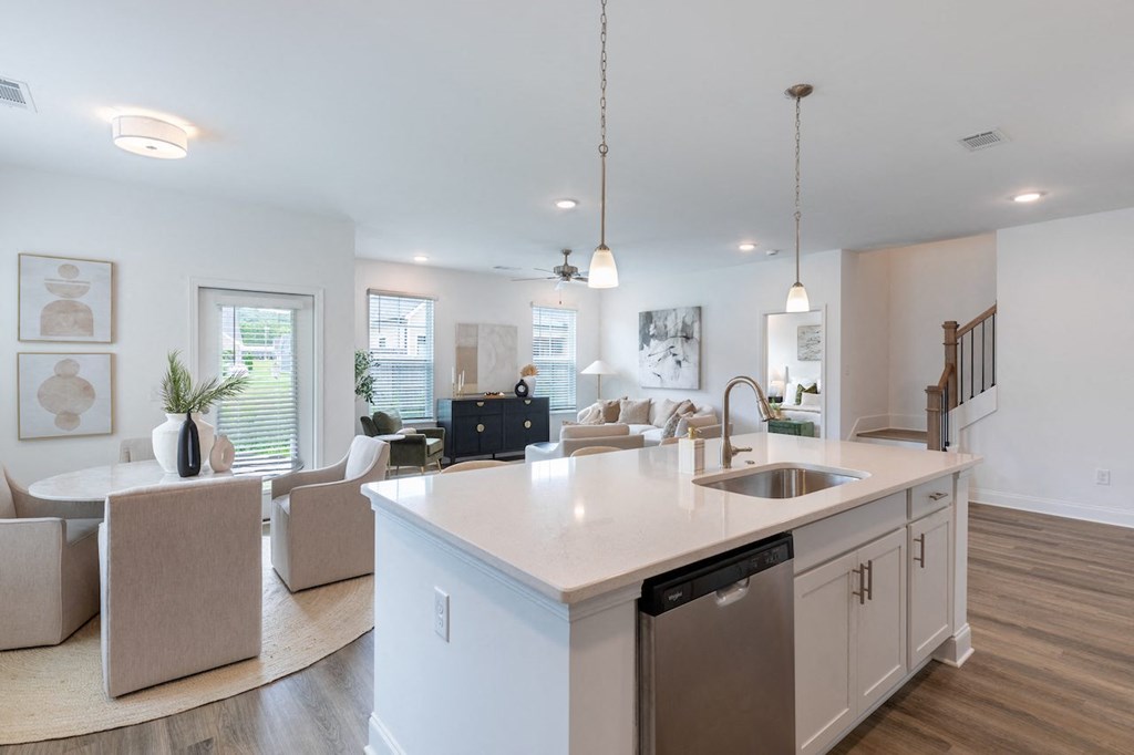 an open kitchen and living room with a large counter top
