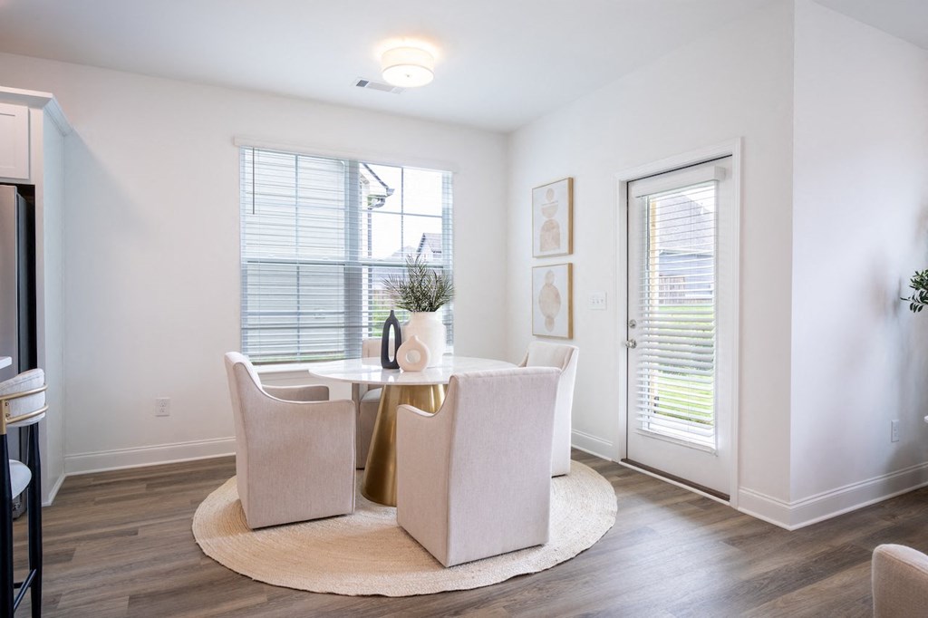 a dining room with a table and chairs
