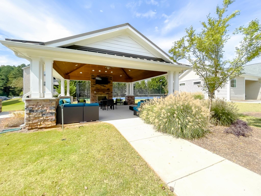 a covered porch with a patio and a house