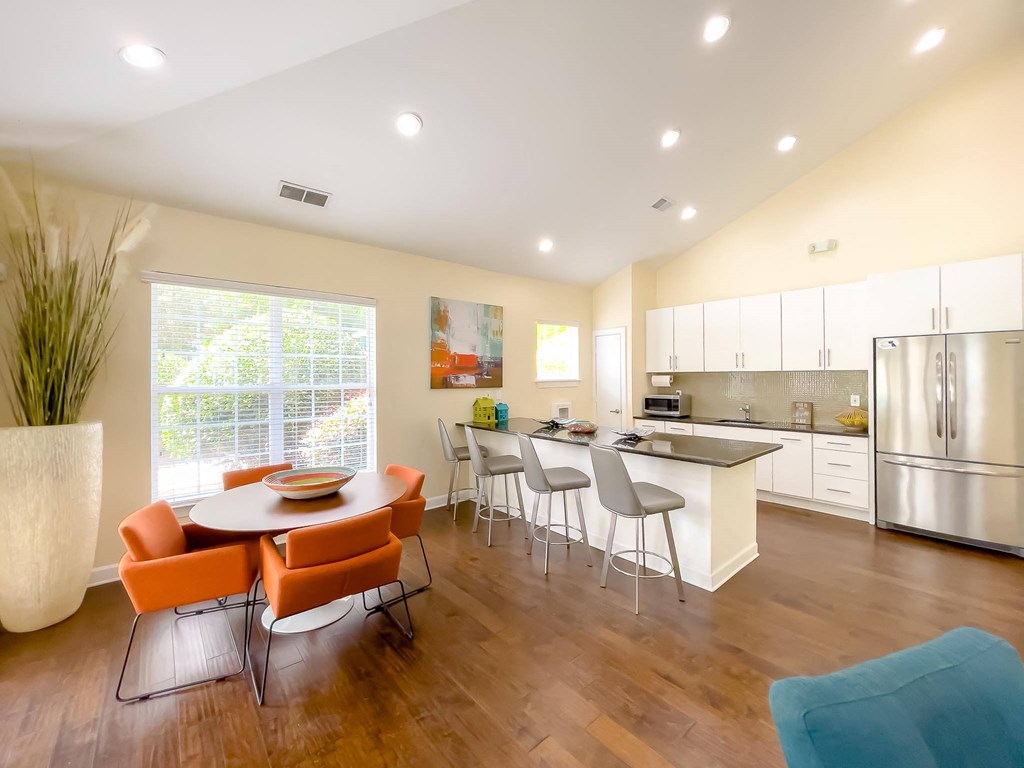 a dining room and kitchen with a table and chairs