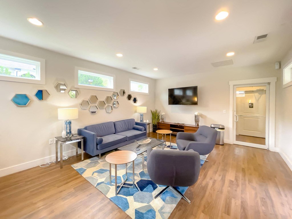 a living room with couches and chairs and a tv