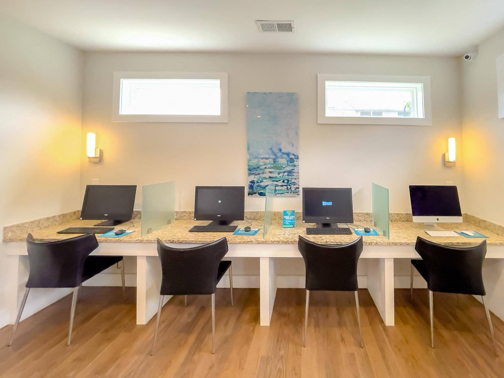 a large table with computers on it in a room