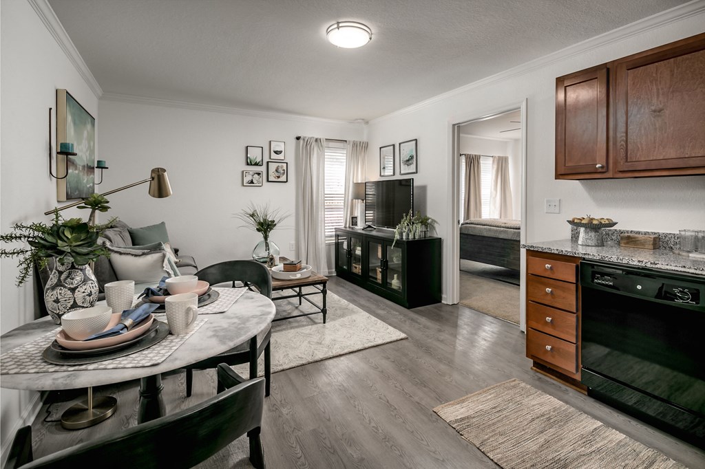 an open living room and kitchen with a dining room table