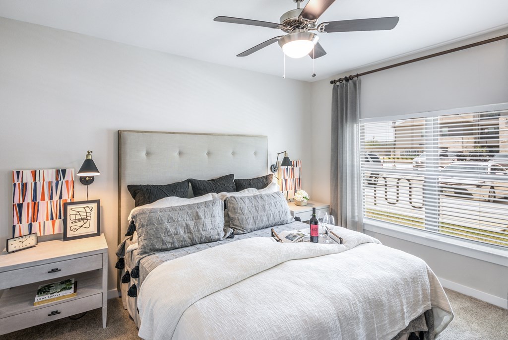 a bedroom with a large bed and a ceiling fan