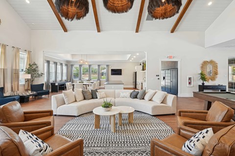 A living room with brown leather chairs and a white sofa.
