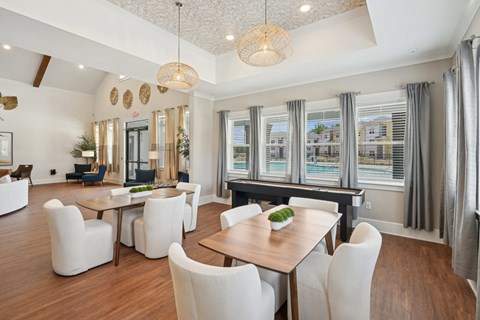 a dining room with a table and chairs and a piano