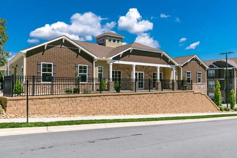 Exterior of the building with a black fence in front.