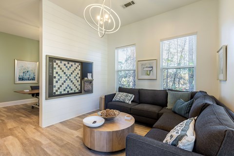 A living room with a dark sofa and a wooden coffee table.