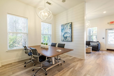 a conference room with a wooden floor and a table with chairs