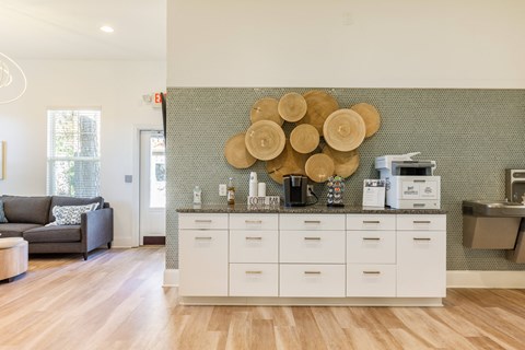 a kitchen with a coffee machine and a counter with plates on the wall