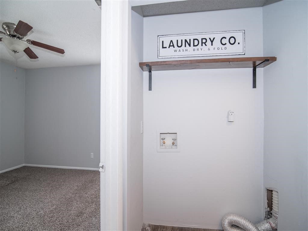 a room with a ceiling fan and a sign on the wall