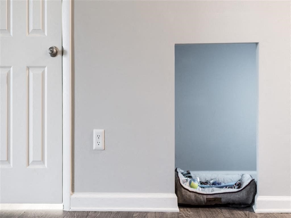 an empty room with a mattress on the floor and a door