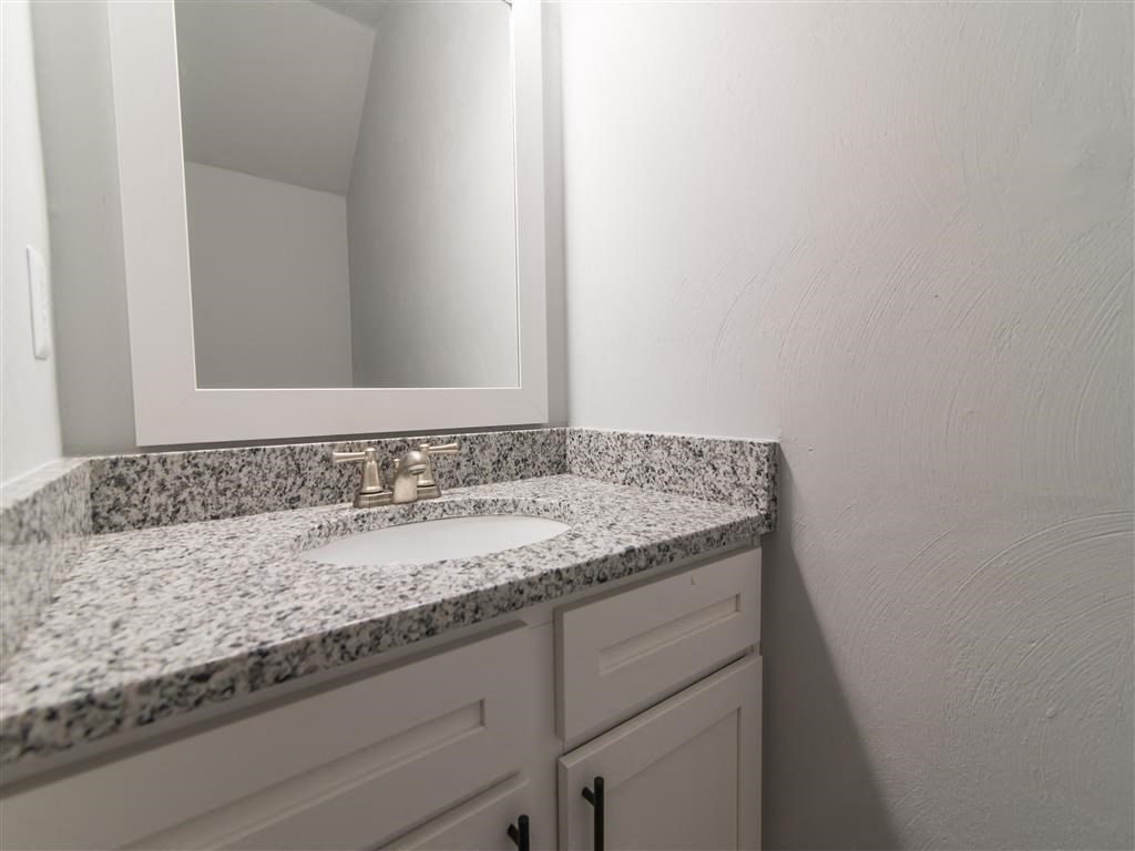 a bathroom with a sink and a mirror