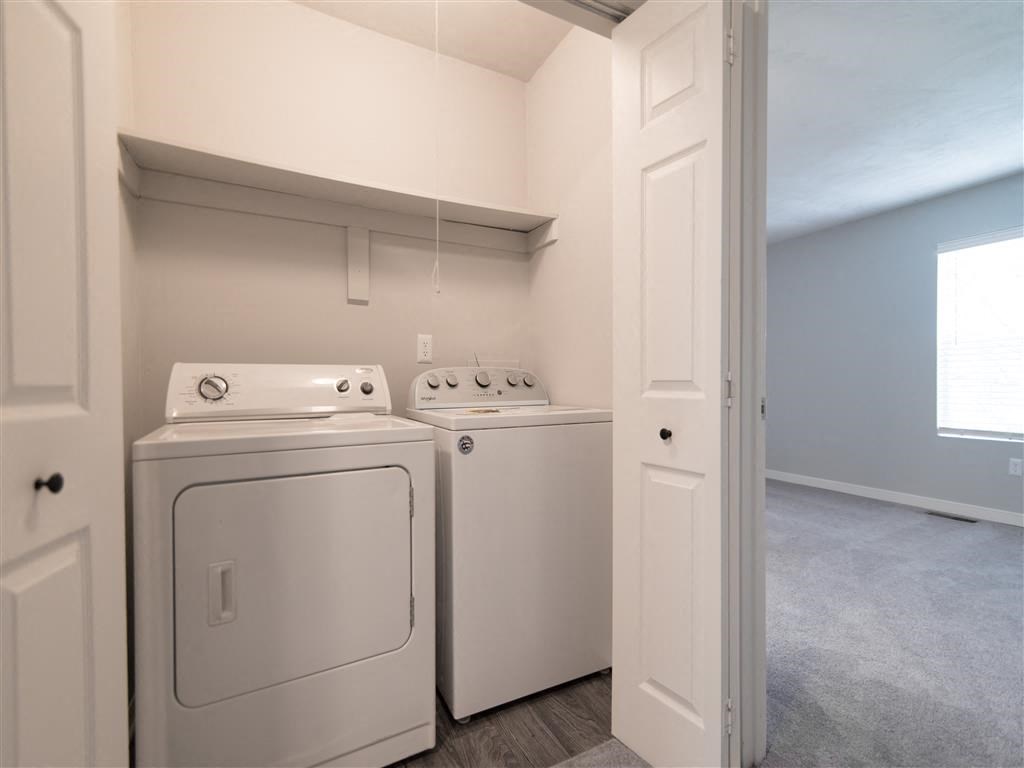 a laundry room with two washes and a dryer in it