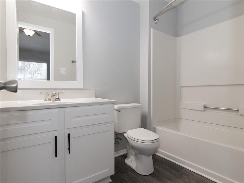 a bathroom with a toilet and a sink and a bath tub