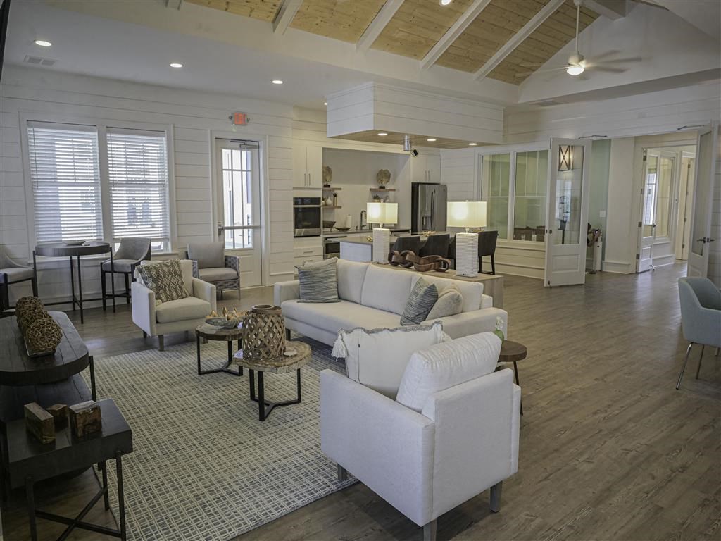 a large living room with couches and chairs