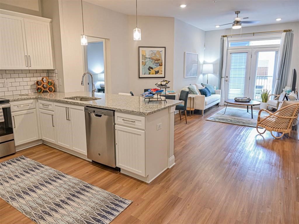 a kitchen with an island and a living room