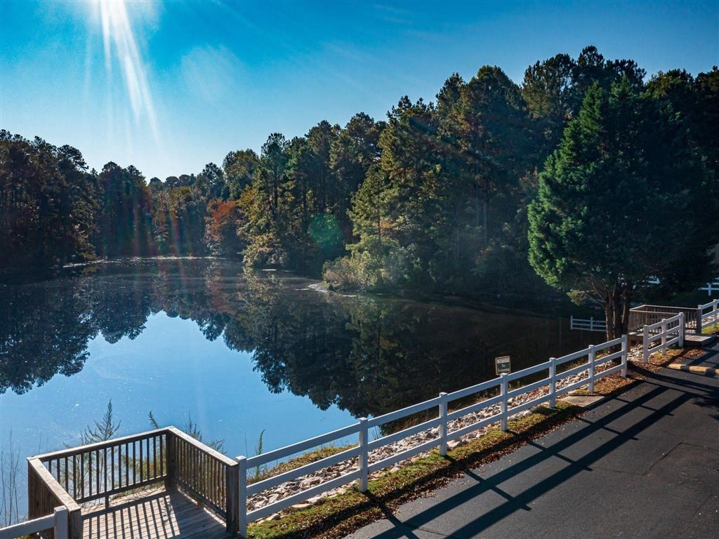 a view of a lake with trees and a bridge