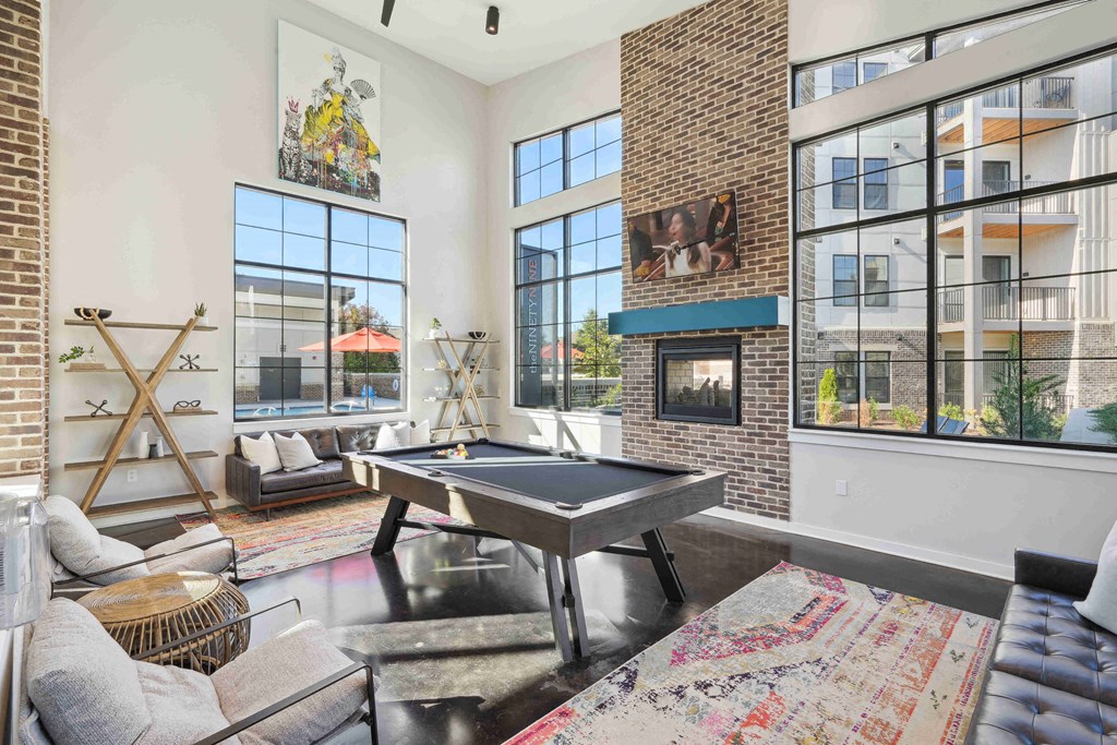 an open living room with a pool table and a fireplace