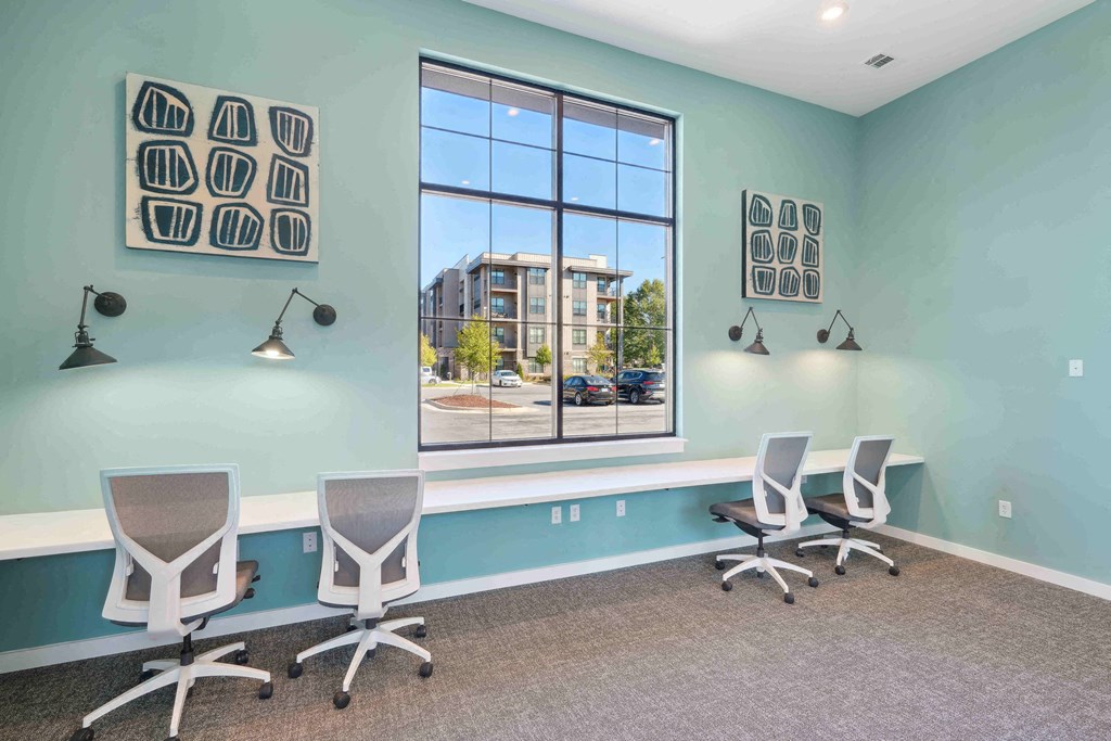 an office with three chairs and a large window