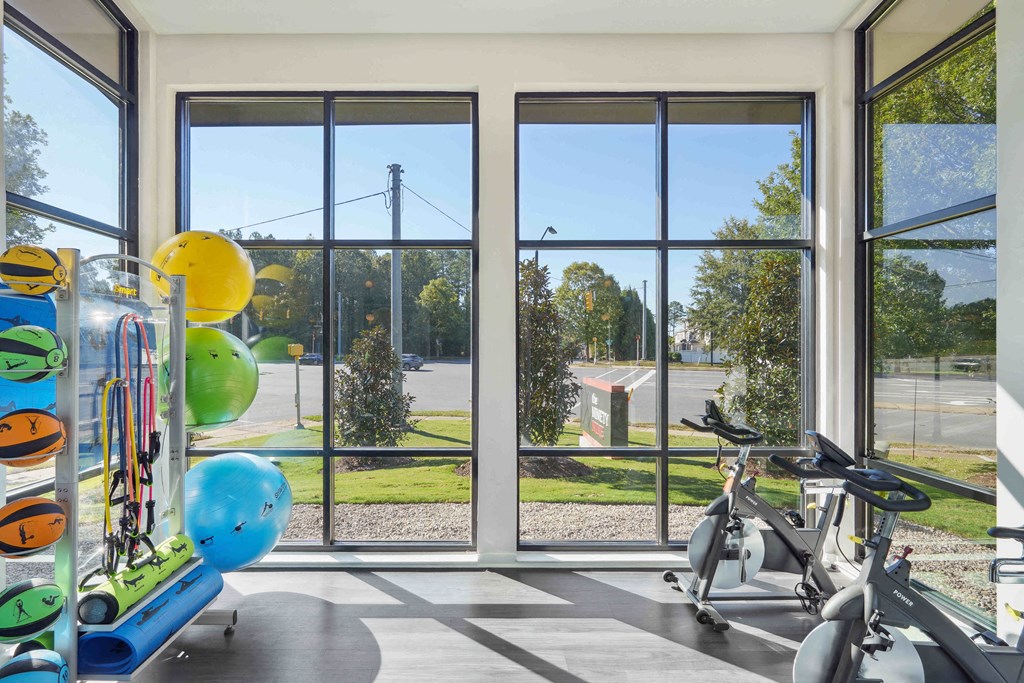 a gym with windows overlooking a park and a playground