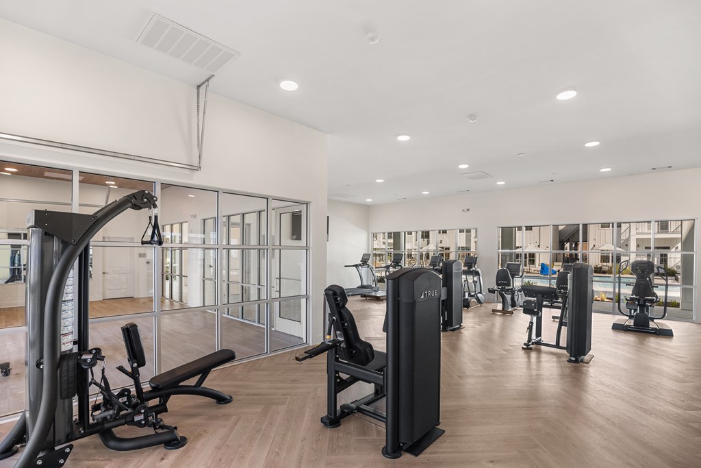 Fitness Center with a variety of equipment including treadmills, weights, and exercise machines.