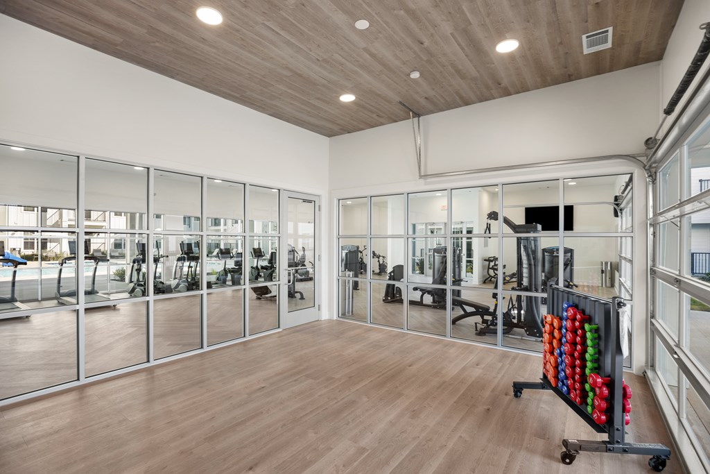 Fitness Center with a variety of equipment and a wall of mirrors.