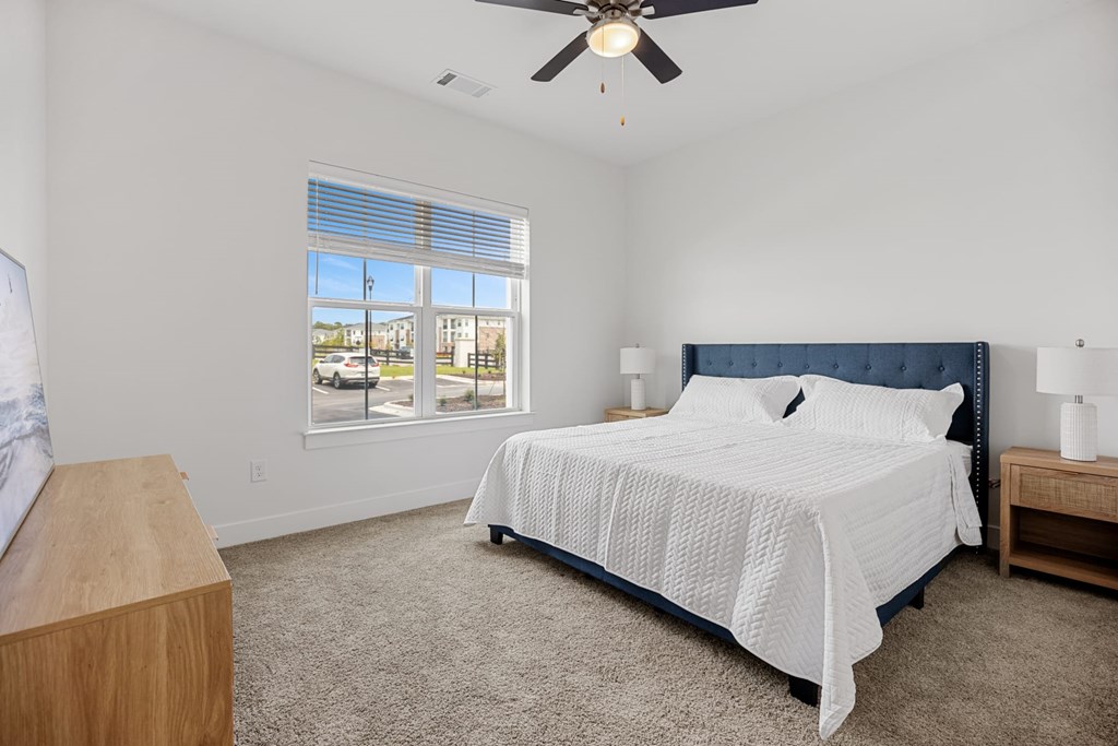 A Bedroom with a Large Bed and a Ceiling Fan.