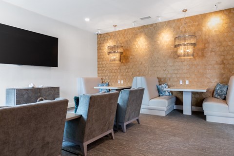A room with a brown wall and a white table with chairs.