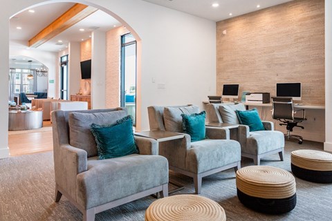 A room with grey couches and a wooden wall.