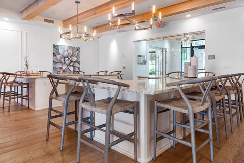 A dining area with a long table and chairs.