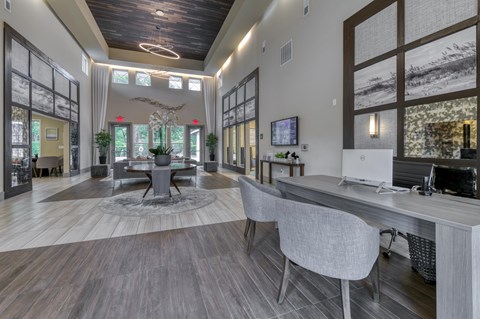 A modern office space with a large desk and chairs.