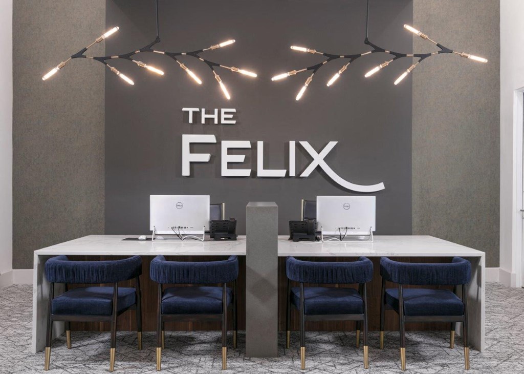 a feelin desk in a room with two laptops