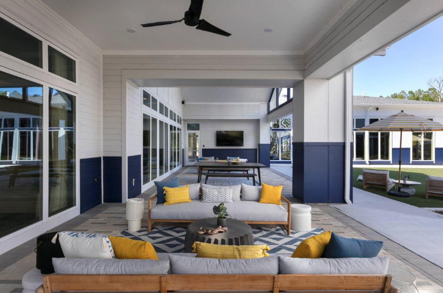 a living room with couches and a table on a patio