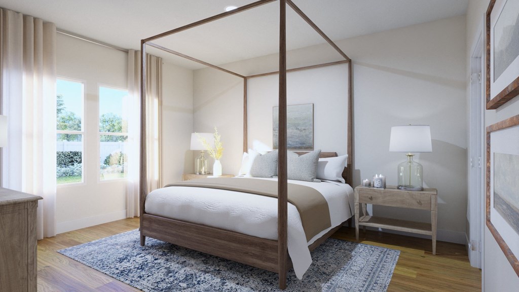 a bedroom with a four poster bed and a blue rug