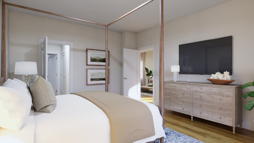 a bedroom with a large bed and a tv