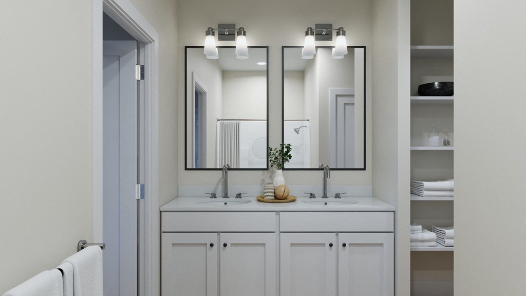 a white bathroom with two sinks and three mirrors