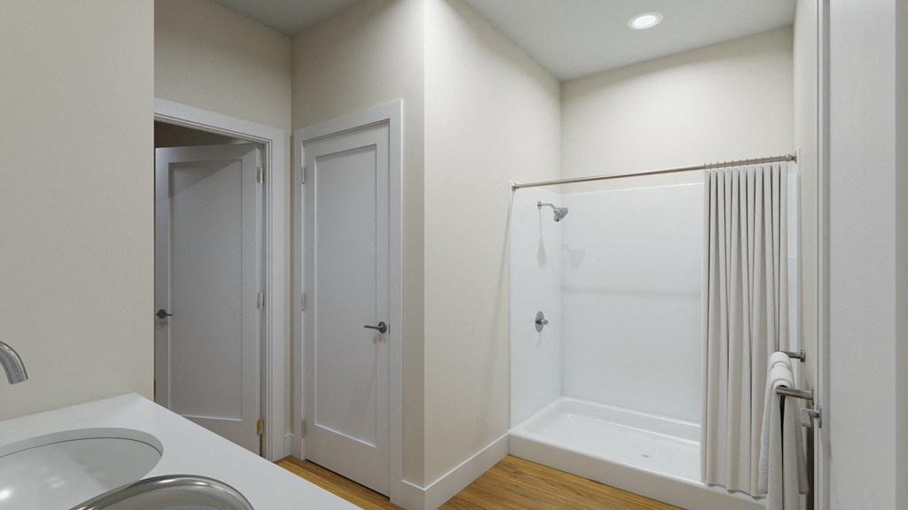 a bathroom with a shower and a sink and a mirror