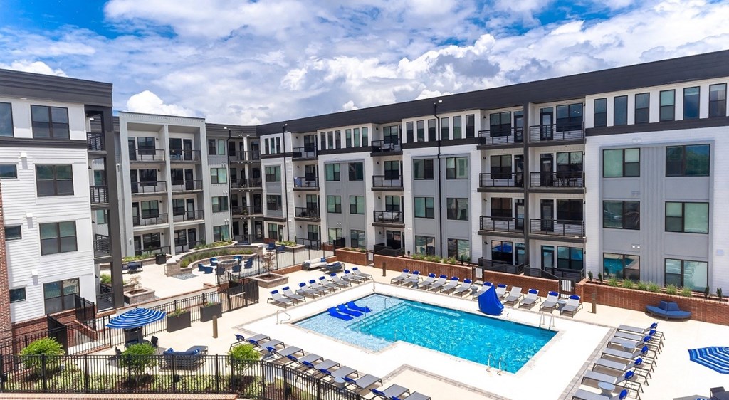 a swimming pool in front of an apartment building
